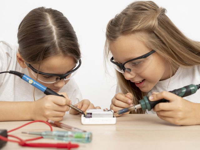 girls-with-safety-glasses-doing-science-experiments-together